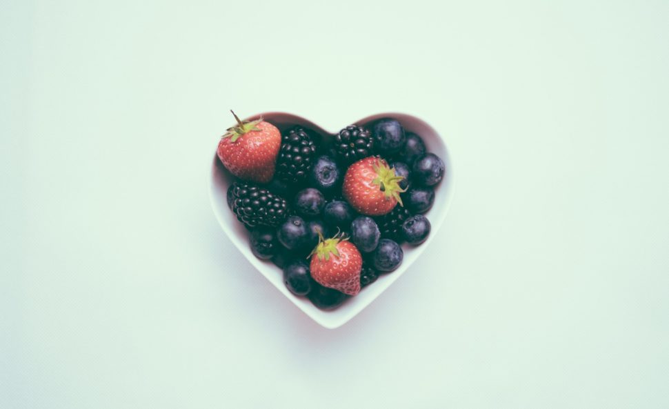 bowl shaped like a heart, filled with blueberries and strawberries