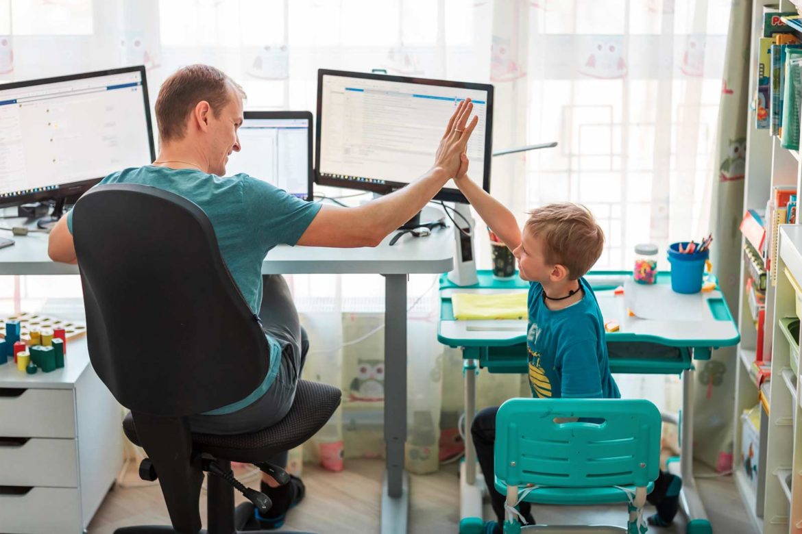 father and son high five in an office