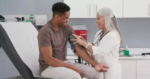 doctor taking a patient's blood pressure